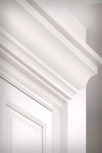 Crown moulding detail. To match cabinet heights from work area and range, we created extra height with custom crown moulding.