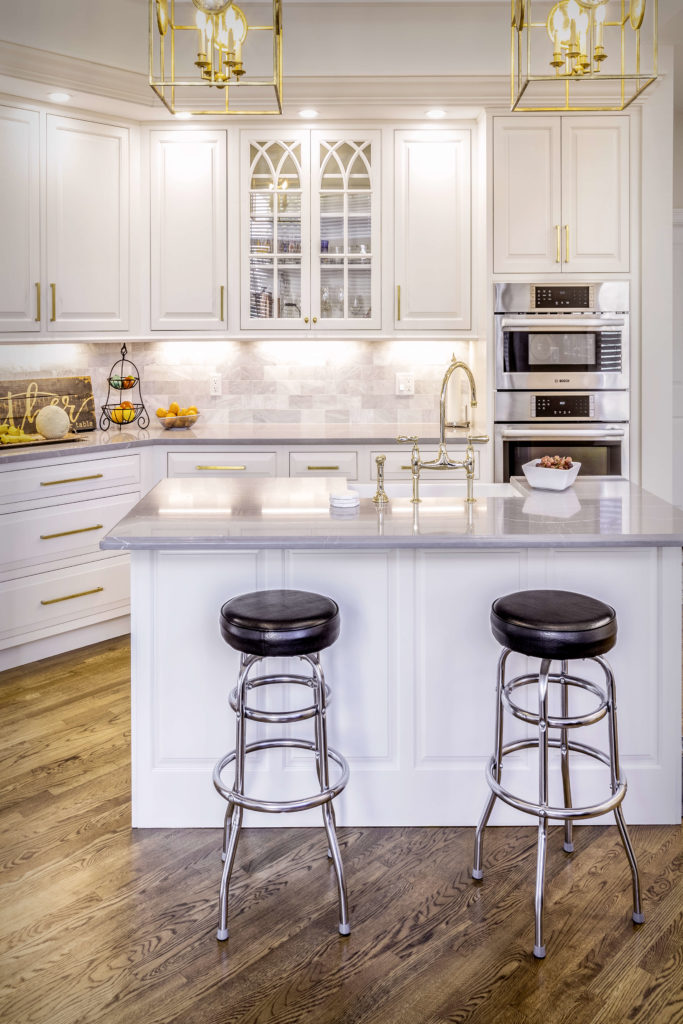 Cromwell kitchen remodel showing the island front, with glass cabinets, inset cabinet doors, and custom crown moulding above the upper cabinets.