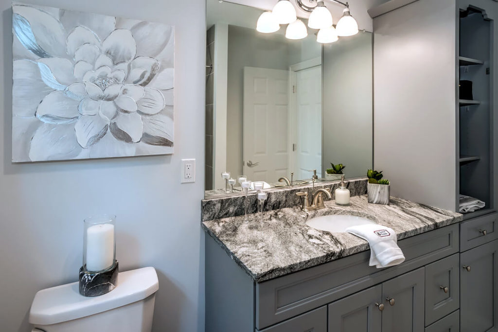 Detail view of bathroom vanity and linen closet in optional grey installed by Viking Kitchens at Gledhill Estates.