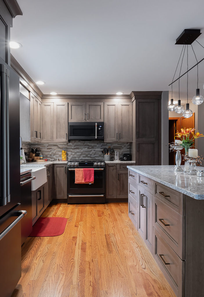 View of the Ultracraft perimeter and island cabinets, Cherry Wood with Wicker Park door style and Coastal Grey stain finish.