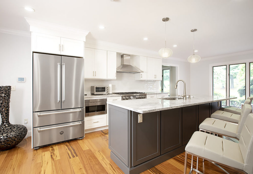 View across the Super White Quartzite counter above Homecrest cabinets in Galaxy Opaque, to the kitchen for area with cabinets in Alpine Opaque.