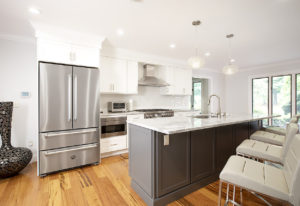 View across the Super White Quartzite counter above Homecrest cabinets in Galaxy Opaque, to the kitchen for area with cabinets in Alpine Opaque.