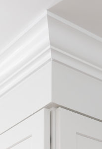 Detail of the upper cabinets, showing custom crown moulding.