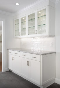 View of the cabinetry in the Butler's Pantry BEFORE work in the West Hartford kitchen remodel showing glass door fronts and interior lighting.
