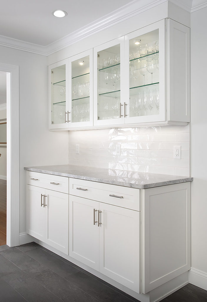 View of the cabinetry in the Butler's Pantry BEFORE work in the West Hartford kitchen remodel showing glass door fronts and interior lighting.