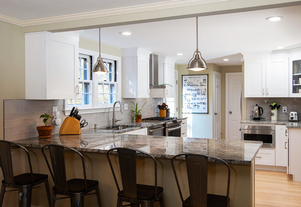 White Wave Granite peninsula island with breakfast bar seating.